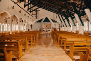 Empty church sanctuary with wooden pews and an altar at the front